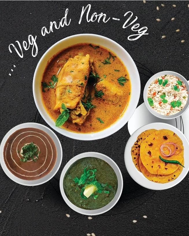 A Simran's Dhaba spread — chicken curry, dal makhani, saag and makki di roti